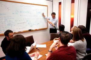 At the white board At the white board